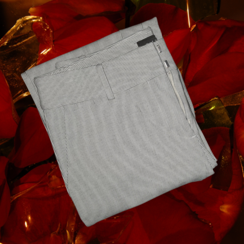 Newport pants grey and white pinstripe folded Large Rose Glass background with deep reds